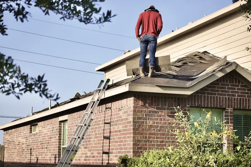 Professional roofer working on a residential roof in Mounds View